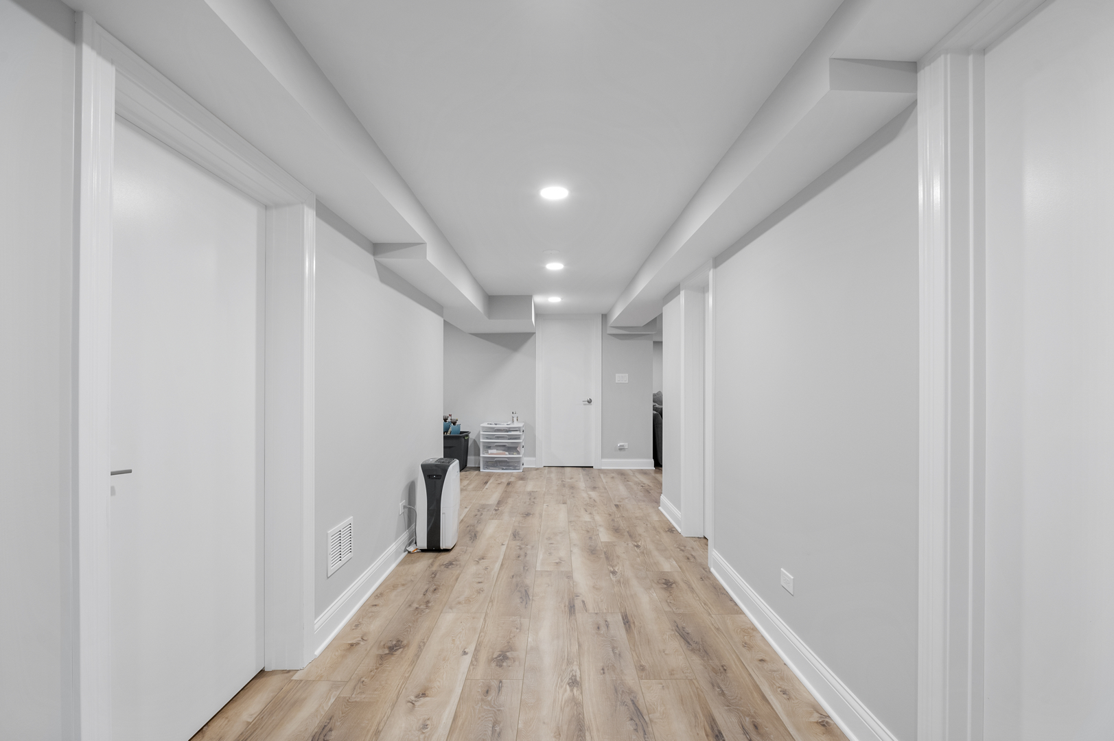 Image of fully remodeled Chicago basement with vinyl wood look-alike floors.