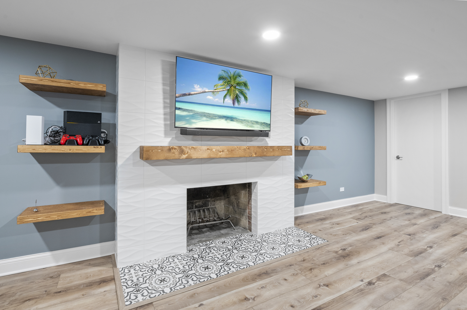  Image of hanging shelves, fireplace, and mounted TV as part of full basement remodel in Chicago.