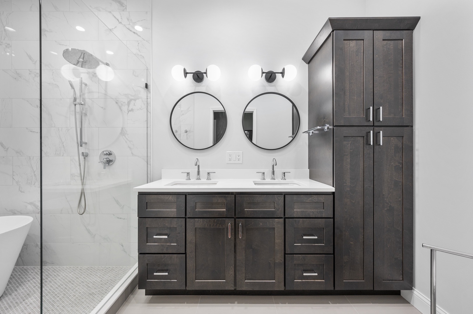 Image of a full bathroom remodel in Chicago with double round mirrors and double ivory sink.
