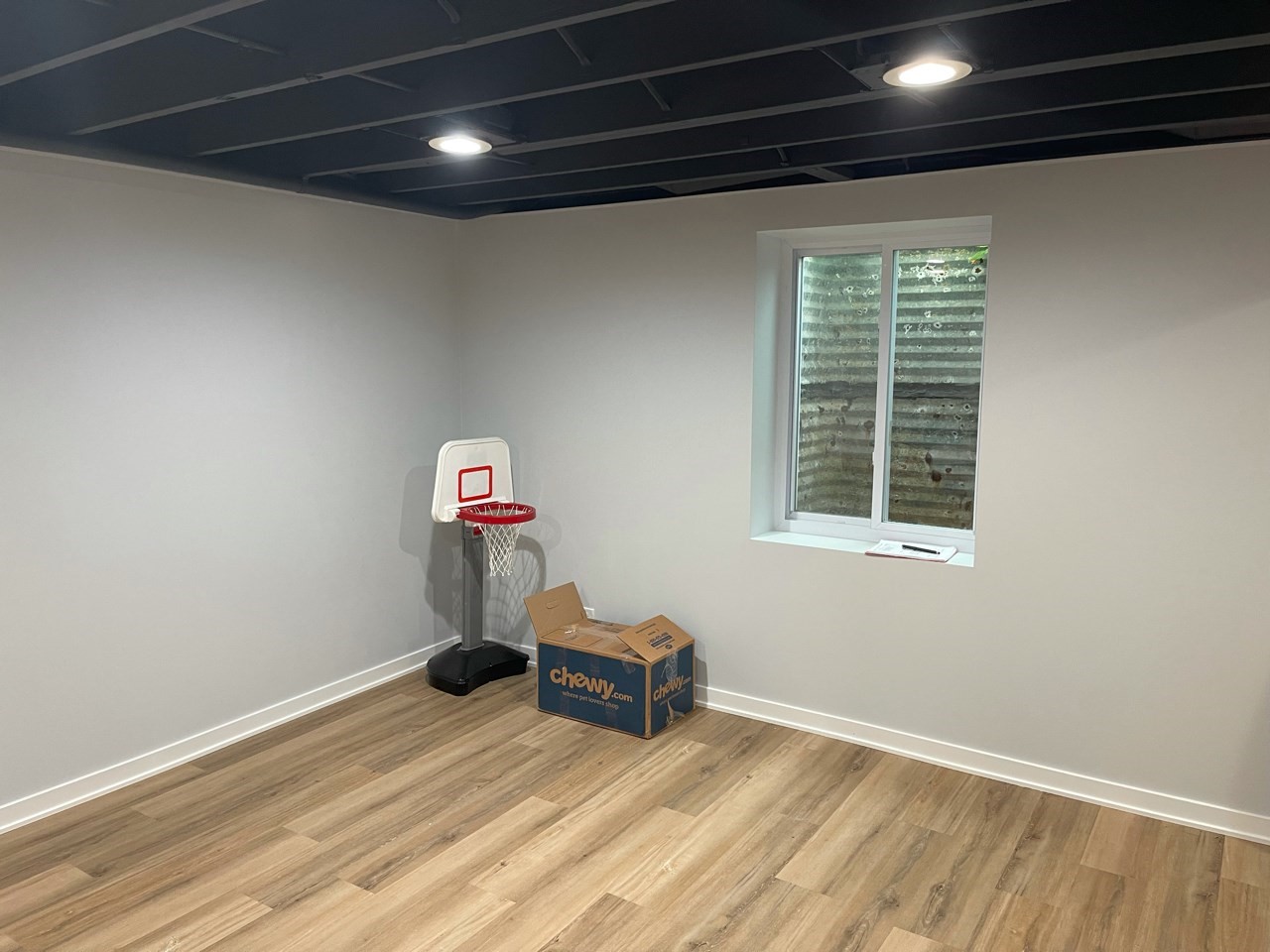 Evanston Basement Remodel With Wood Look Alike Floor And White Walls