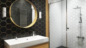 A bathroom with black tile behind a white vanity and a white tile shower