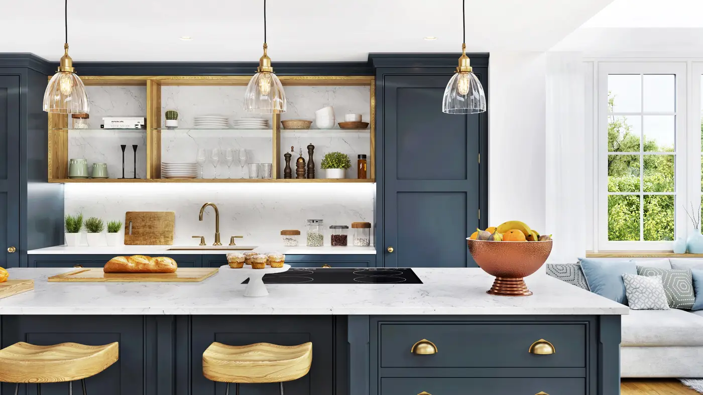 A kitchen with blue cabinets and white countertops with gold fixtures 