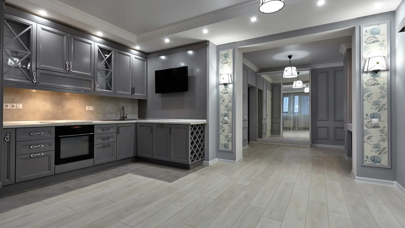 A kitchen home addition with dark gray cabinets and light gray flooring