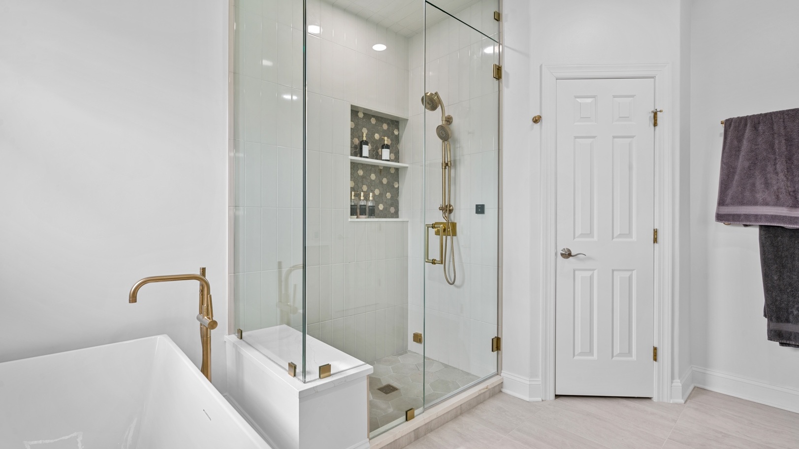 Master bathroom with a walk-in shower and stand alone tub