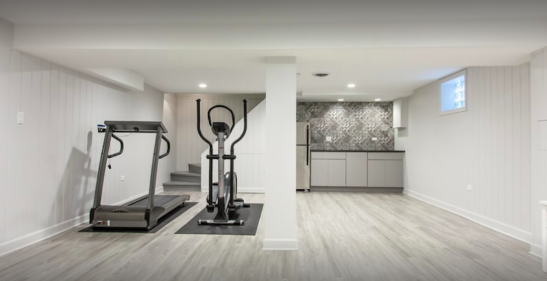 A photo of a dining room and workout room that has been newly remodeled by 4Ever Remodeling in the Chicago area.