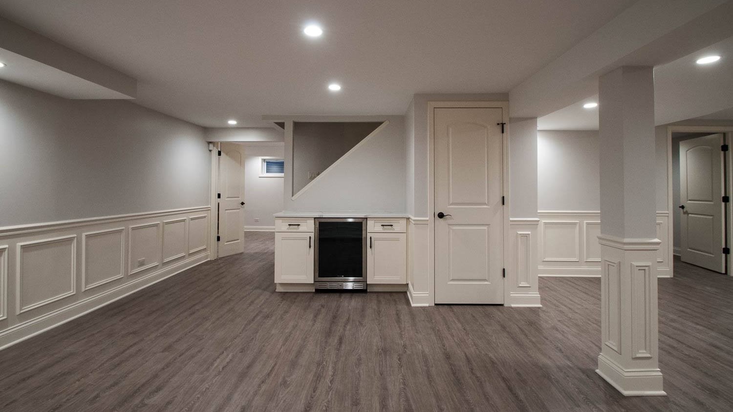 Newly remodeled basement with beautiful wood flooring and mini kitchen in Oak Park, IL by 4Ever Remodeling