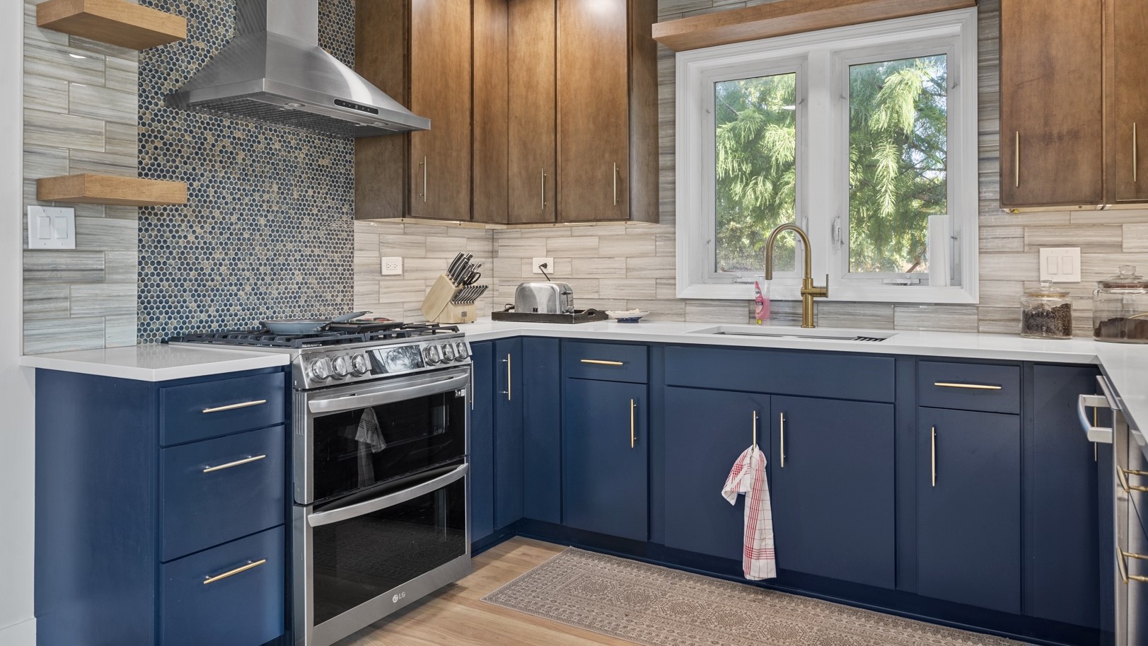 Modern kitchen remodel with beautiful wood floors, marble countertops, and blue cabinetry by 4Ever Remodeling in Oak Park, IL