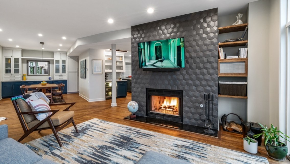 Oak Park, IL home living room with beautiful fireplace, hardwood floors, and open-concept kitchen