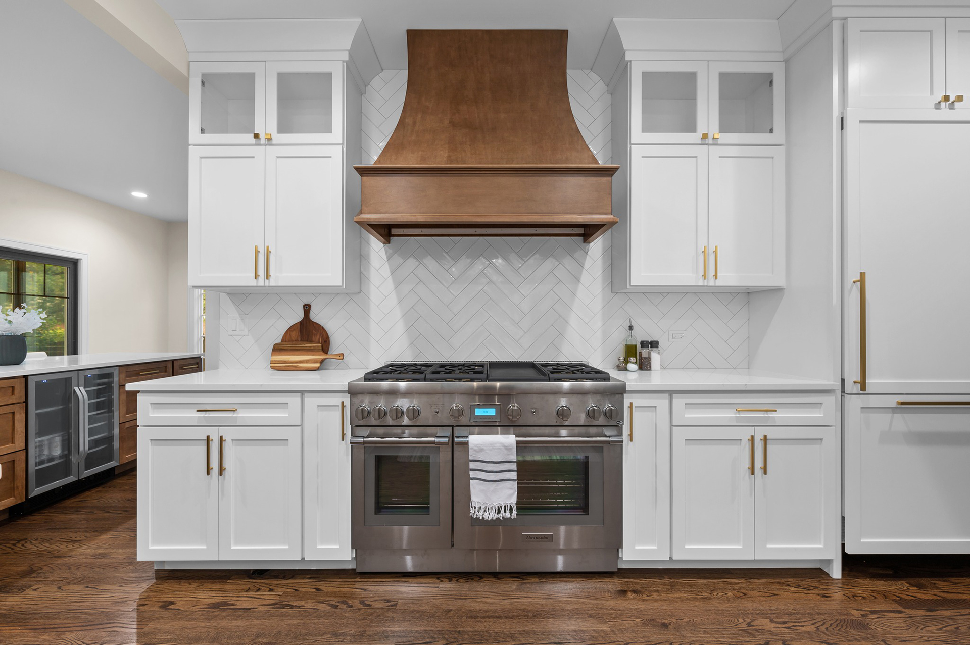 Kitchen In River Forest, Hood, Stove and White Cabinets