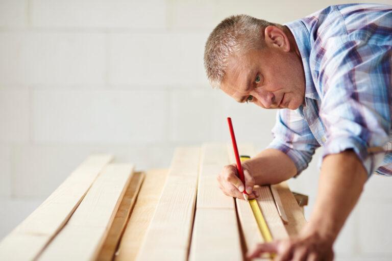 Measure wooden material twice by carpenter