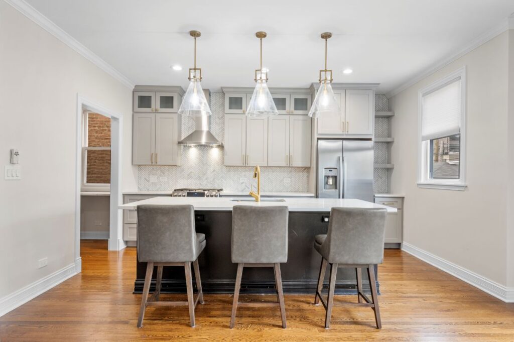 New, bright kitchen with lights above the kitchen island