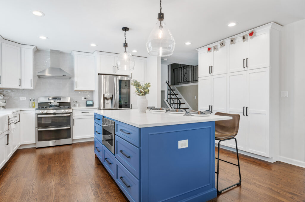 Blue kitchen island in a white, newly remodeled kitchen