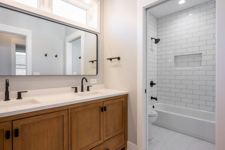 new white bathroom with wooden cabinets